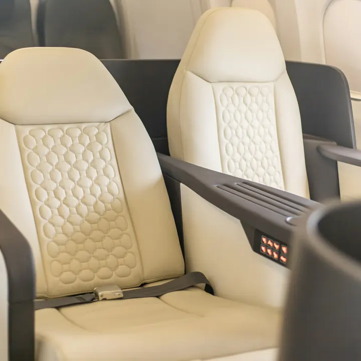 A cream leather seat in a private aircraft cabin