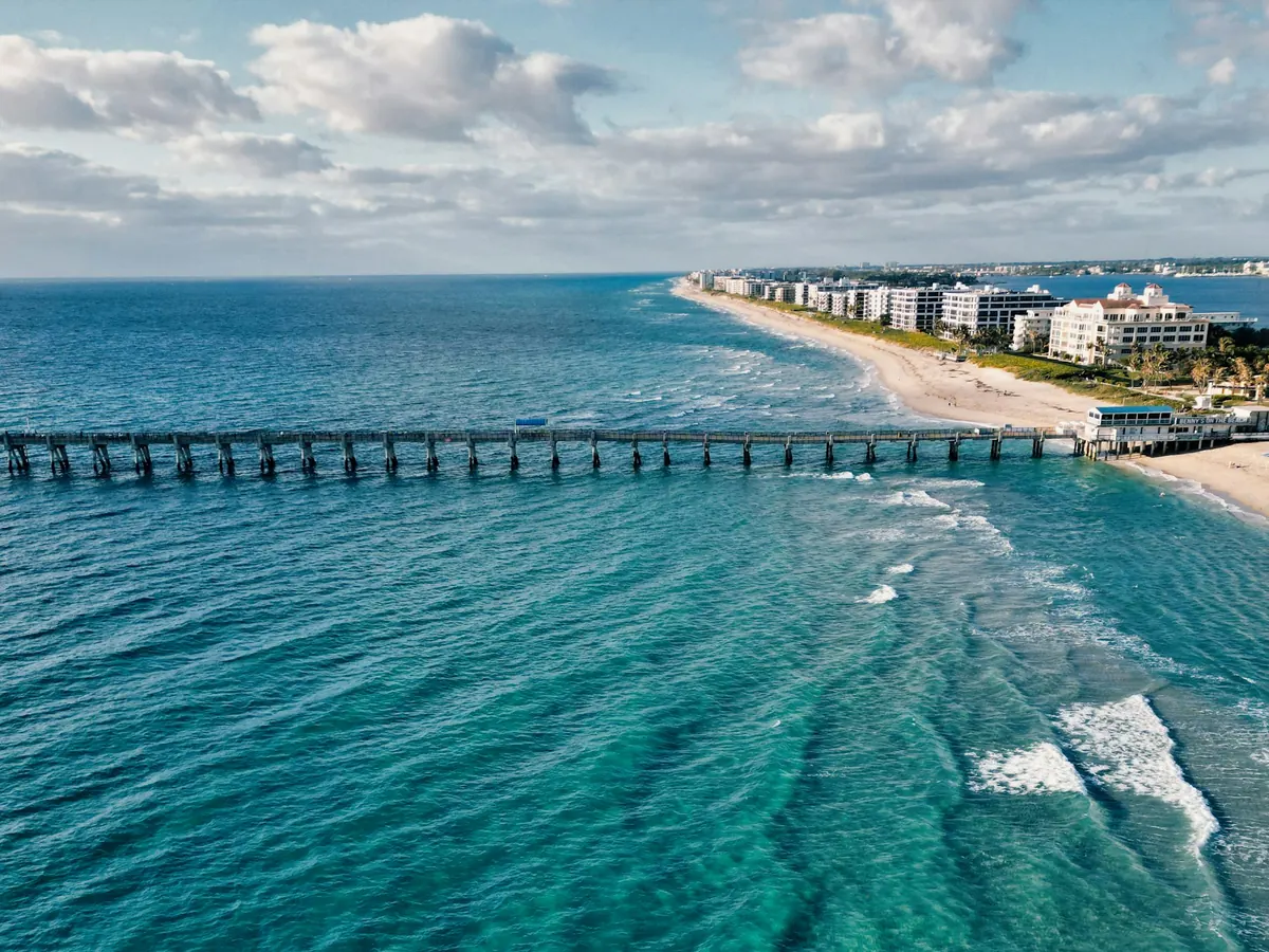 Aerial view of a pier and beach on Florida’s Atlantic coast