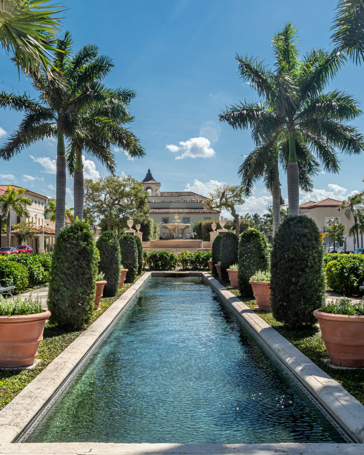 A fountain and palms in a formal Palm Beach garden