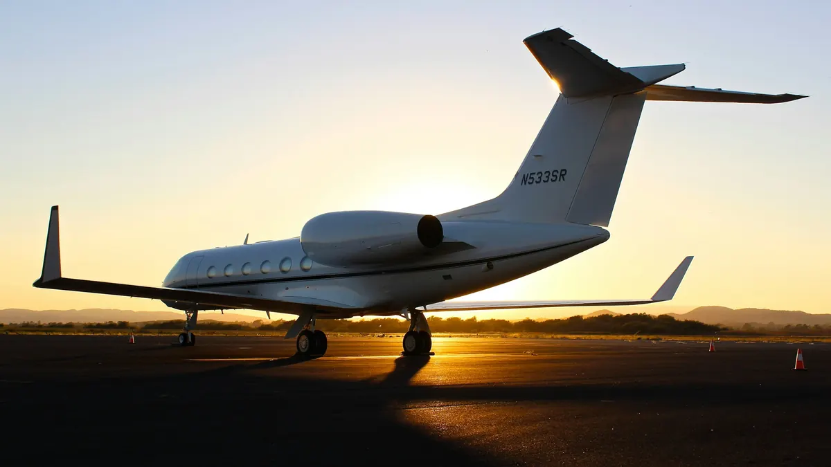 A Gulfstream jet on the ramp at sunset